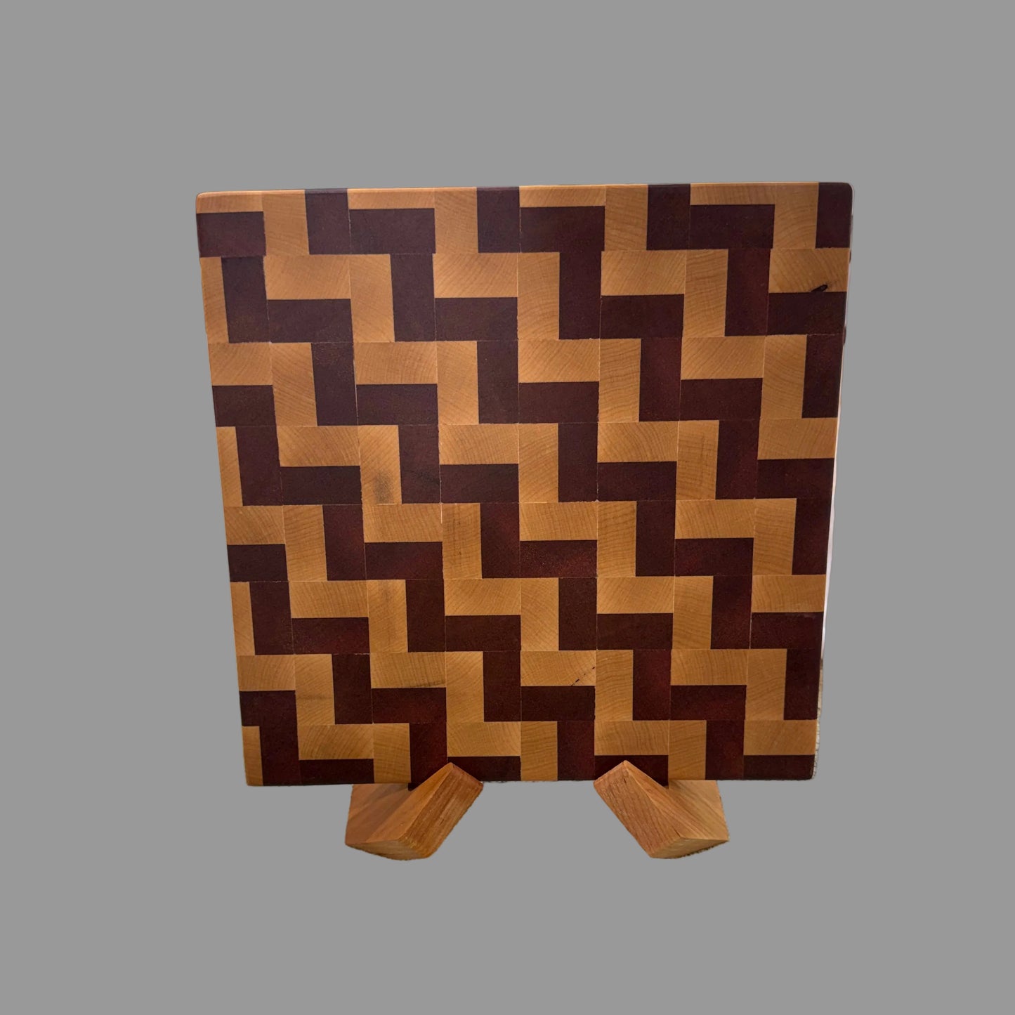 Close-up of maple and sapele chevron end-grain pattern on handcrafted cutting board