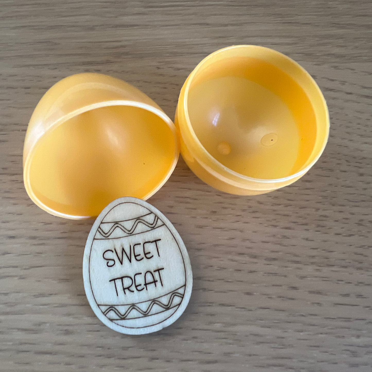Easter Egg Tokens by Wet Nose Woodworks are laser-engraved wood pieces with rewards like “Karaoke Sing-Along,” “Pizza Night,” and dollar amounts—ideal for Easter egg hunts or as charming keepsakes.