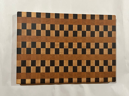 Wooden cutting board with a checkered pattern on a white surface