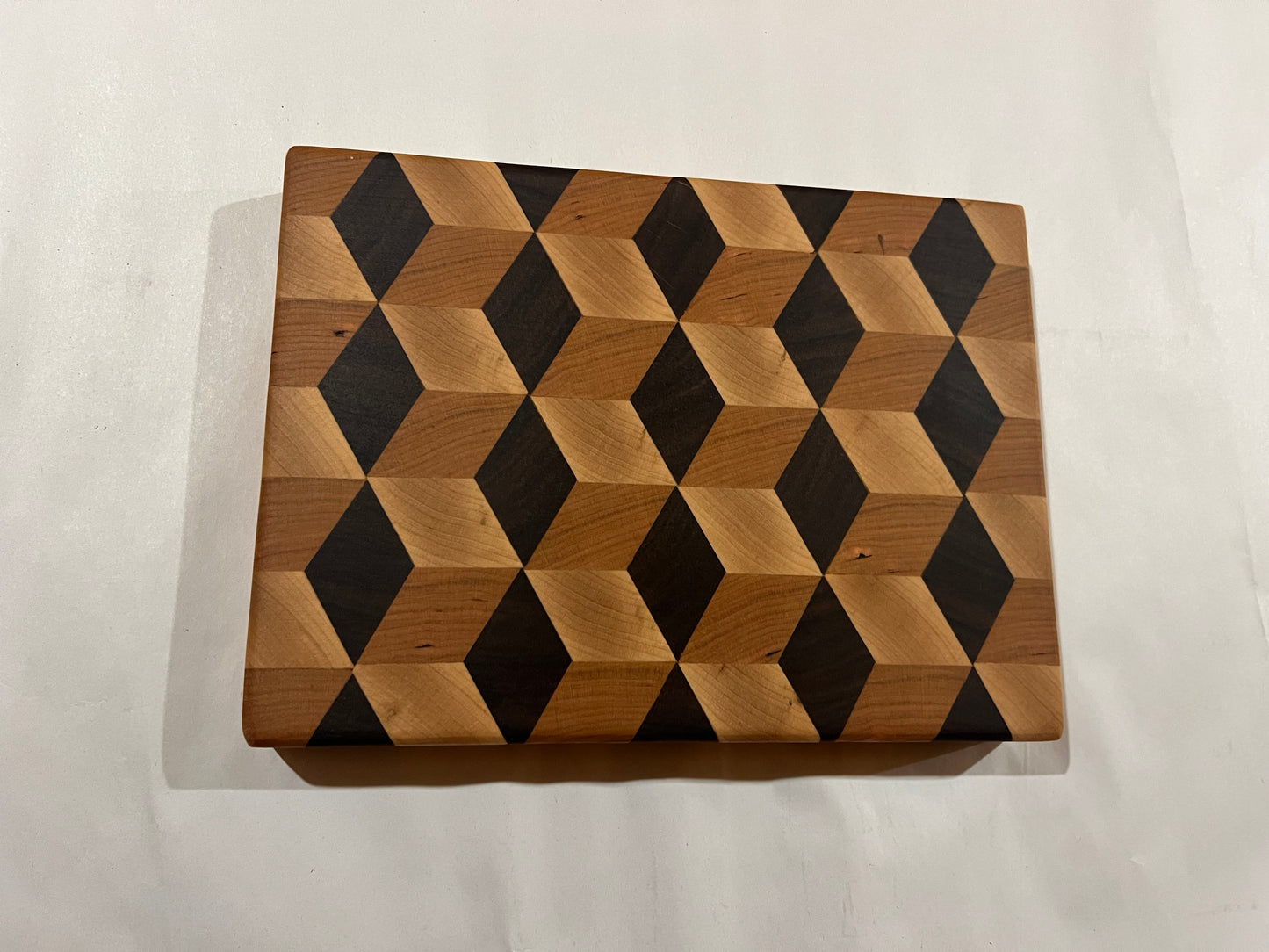 Wooden cutting board with geometric pattern on a white background