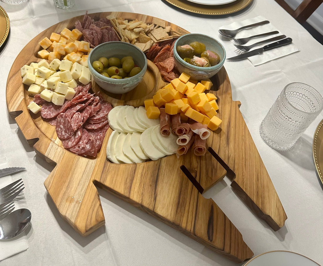 Summer charcuterie board styled with fruit, cheese, and meats on a handmade hardwood serving board