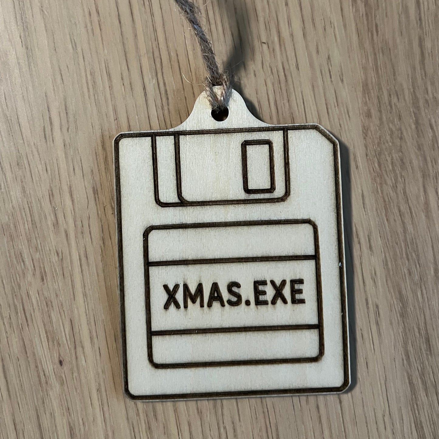Ferrero Rocher chocolate with a 'XMAS.EXE' label on a wooden surface