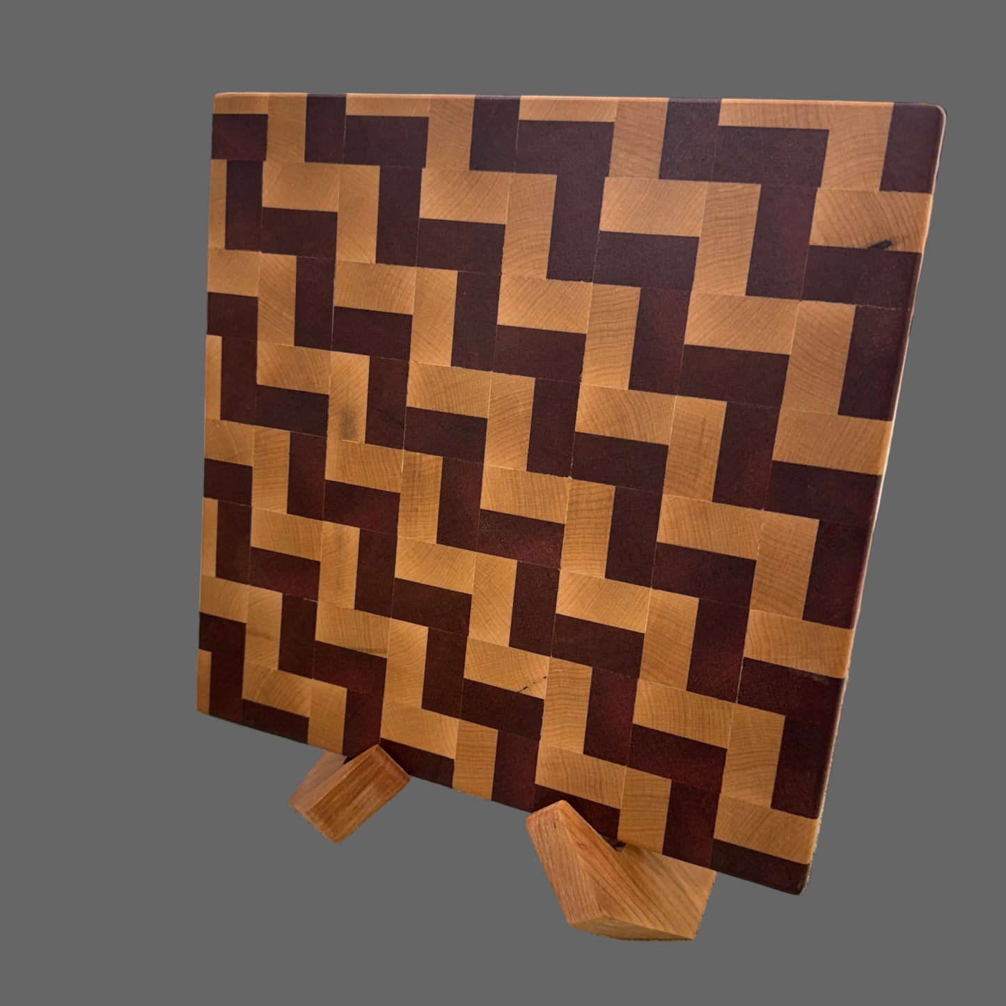 Wooden cutting board with a zigzag pattern on a concrete surface