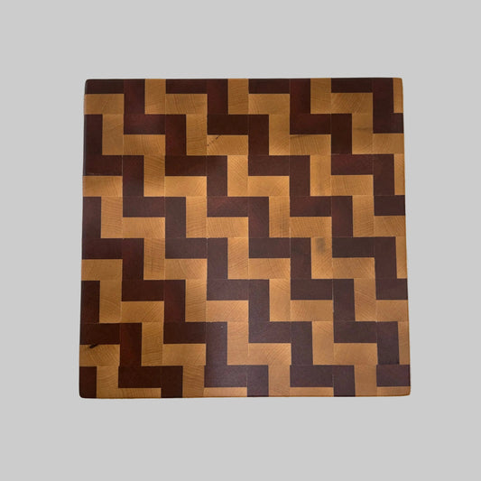 Wooden cutting board with a zigzag pattern on a white background
