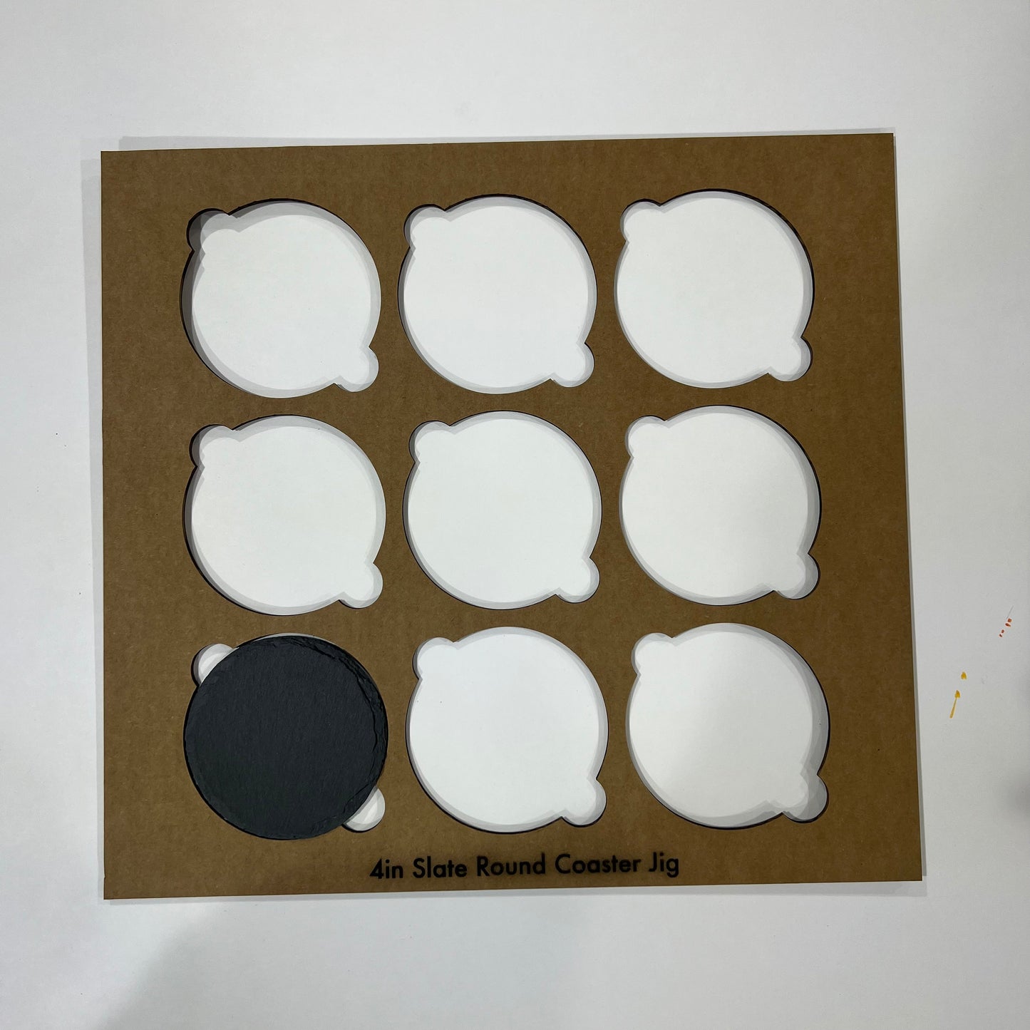 A collage displays circular and square 4-inch black slate coaster jigs by Wet Nose Woodworks, featuring SVG files for laser engraving, with “Black Slate Coasters Alignment Jig Bundle Pack Digital Files” across the center.