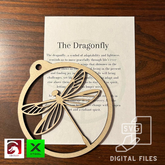 A Digital Dragonfly Ornament & Inspirational Card file by Wet Nose Woodworks rests on a printed card titled The Dragonfly. SVG and laser-cutting file logos show its perfect for DIY crafters using Glowforge, xTool, or other laser cutters.