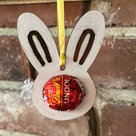 The Wet Nose Woodworks Digital Easter Lindt Holder Ornament features bunny and egg designs—SVG, PNG, PDF files for laser cutting—perfect DIY inspiration for crafters making Easter ornaments with Lindt chocolates.
