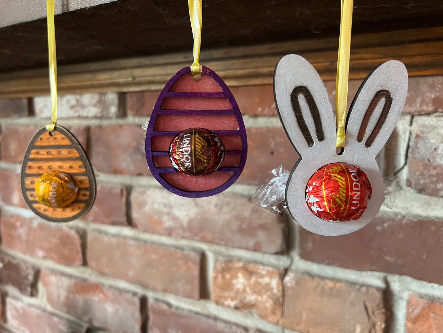 The Wet Nose Woodworks Digital Easter Lindt Holder Ornament features bunny and egg designs—SVG, PNG, PDF files for laser cutting—perfect DIY inspiration for crafters making Easter ornaments with Lindt chocolates.
