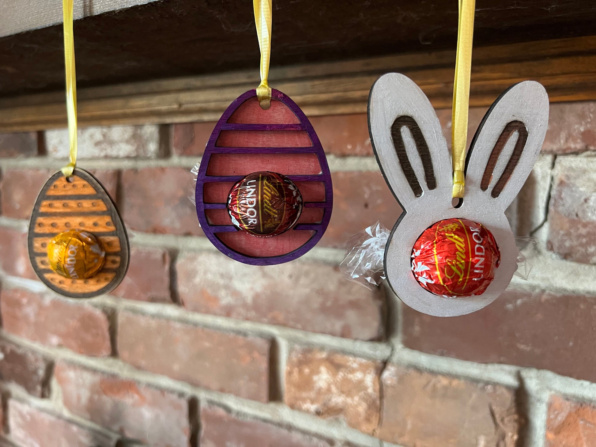 The Wet Nose Woodworks Digital Easter Lindt Holder Ornament features bunny and egg designs—SVG, PNG, PDF files for laser cutting—perfect DIY inspiration for crafters making Easter ornaments with Lindt chocolates.
