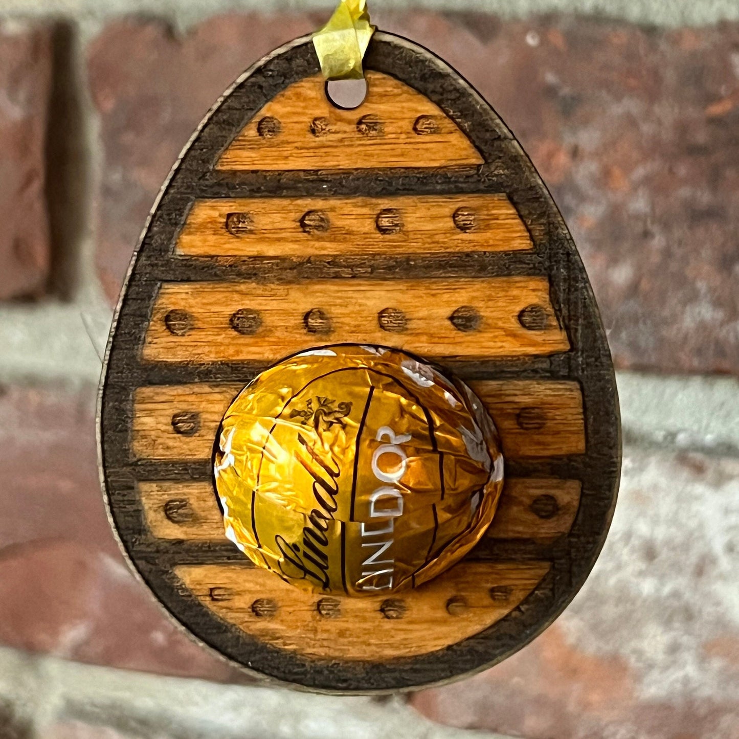 The Wet Nose Woodworks Digital Easter Lindt Holder Ornament features bunny and egg designs—SVG, PNG, PDF files for laser cutting—perfect DIY inspiration for crafters making Easter ornaments with Lindt chocolates.