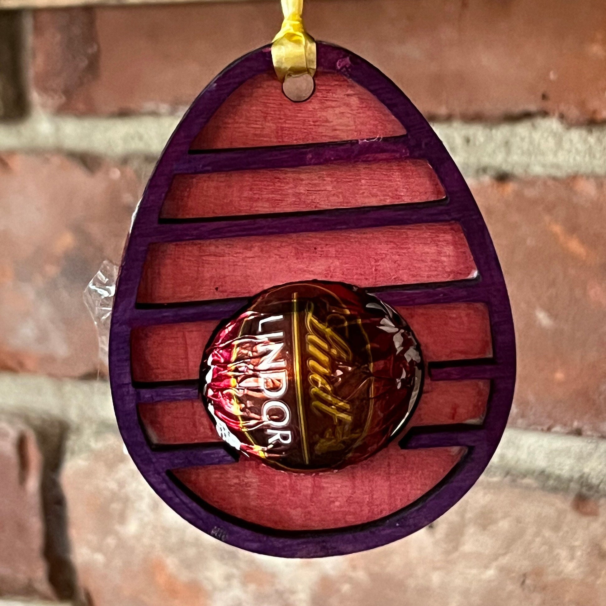 The Wet Nose Woodworks Digital Easter Lindt Holder Ornament features bunny and egg designs—SVG, PNG, PDF files for laser cutting—perfect DIY inspiration for crafters making Easter ornaments with Lindt chocolates.