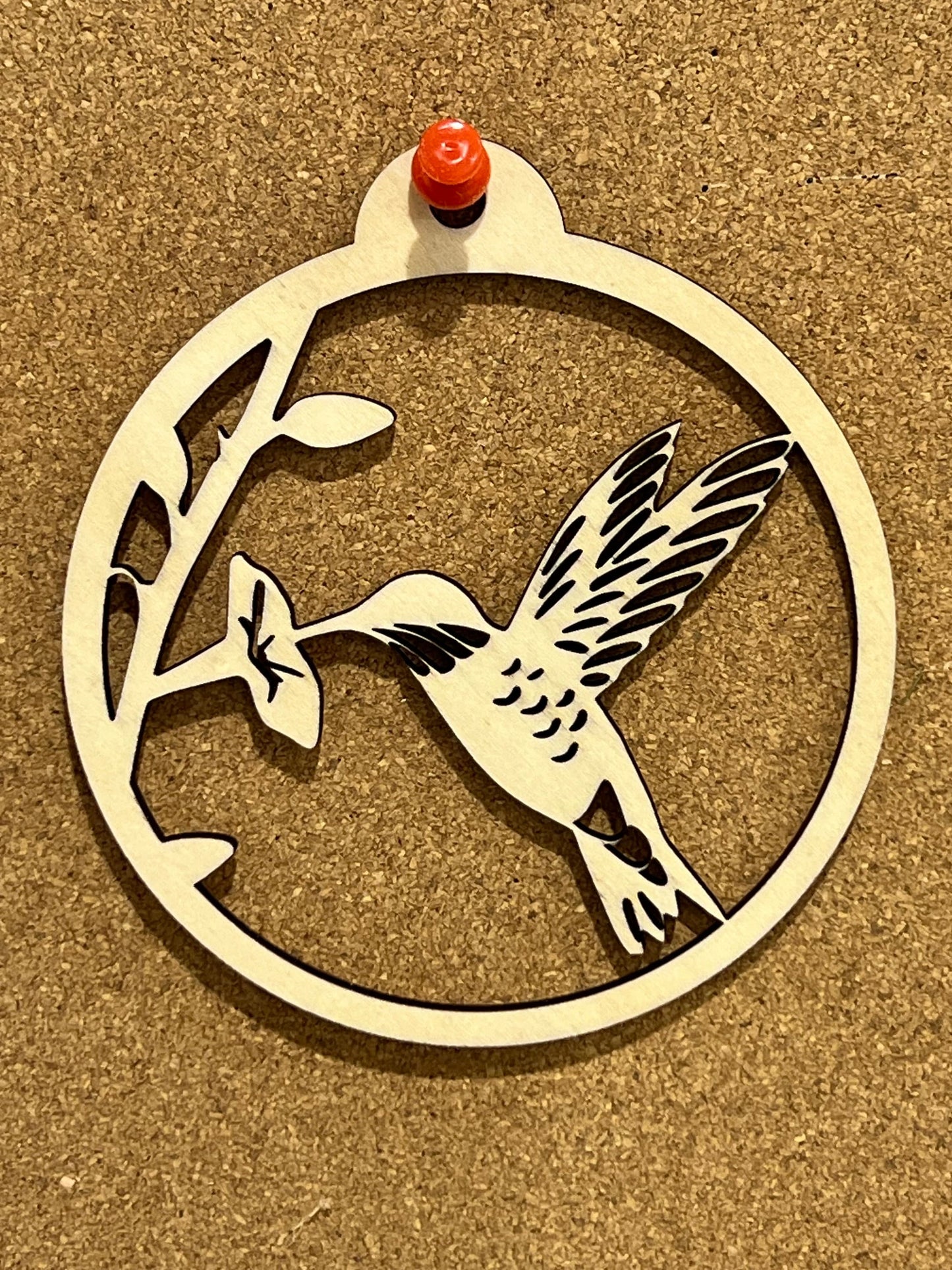 The Digital Hummingbird Ornament by Wet Nose Woodworks features a circular design of a hummingbird and flower, perfect as a DIY laser cut craft. Includes inspirational card files in PDF, SVG, and Lightburn formats—ideal for gifting and decor.