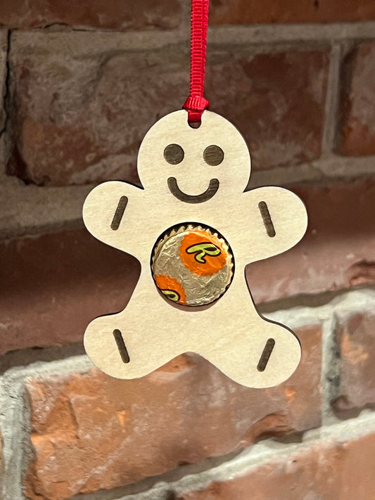 The Wet Nose Woodworks Digital Ornament Template features a gingerbread man design that holds a Reeses peanut butter cup, perfect for festive projects. Includes SVG and Lightburn files laser-ready for use with your ornament designs.