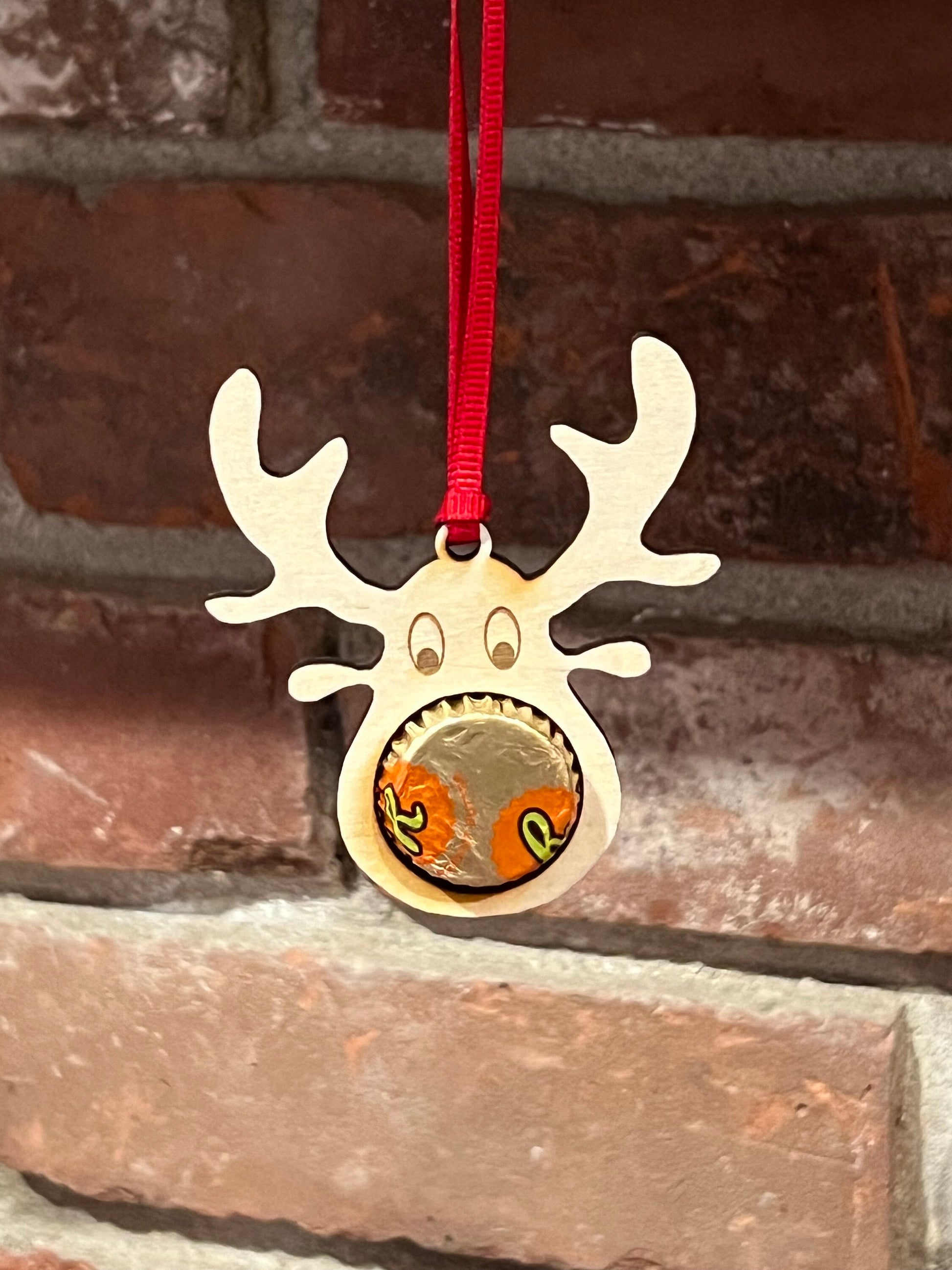The Wet Nose Woodworks Digital Ornament Template features a gingerbread man design that holds a Reeses peanut butter cup, perfect for festive projects. Includes SVG and Lightburn files laser-ready for use with your ornament designs.