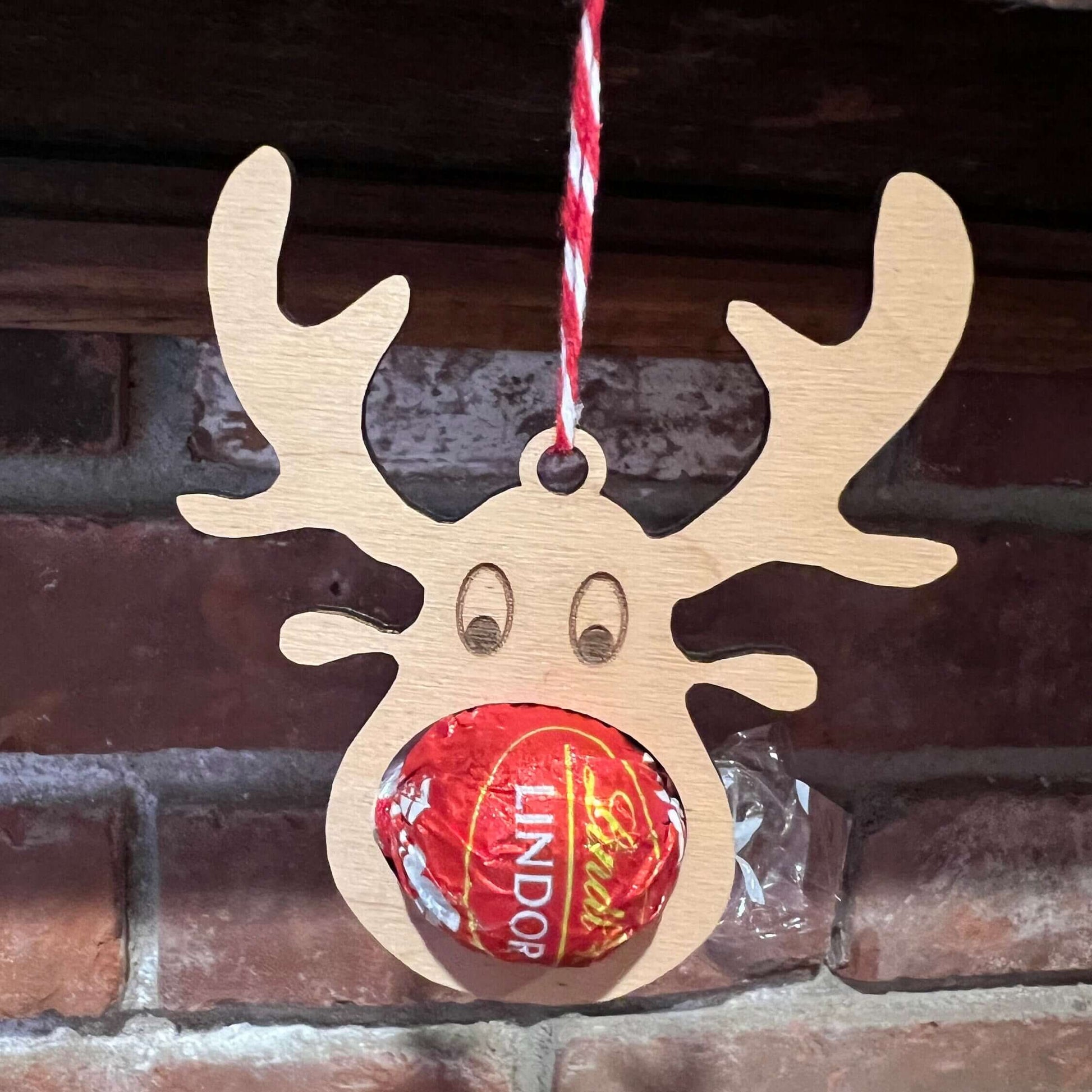 The Wet Nose Woodworks Digital Ornament Templates include a reindeer Lindt Lindor chocolate holder—perfect for festive designs. This laser-ready SVG/Lightburn file set features gingerbread man, snowflake, and reindeer ornaments.