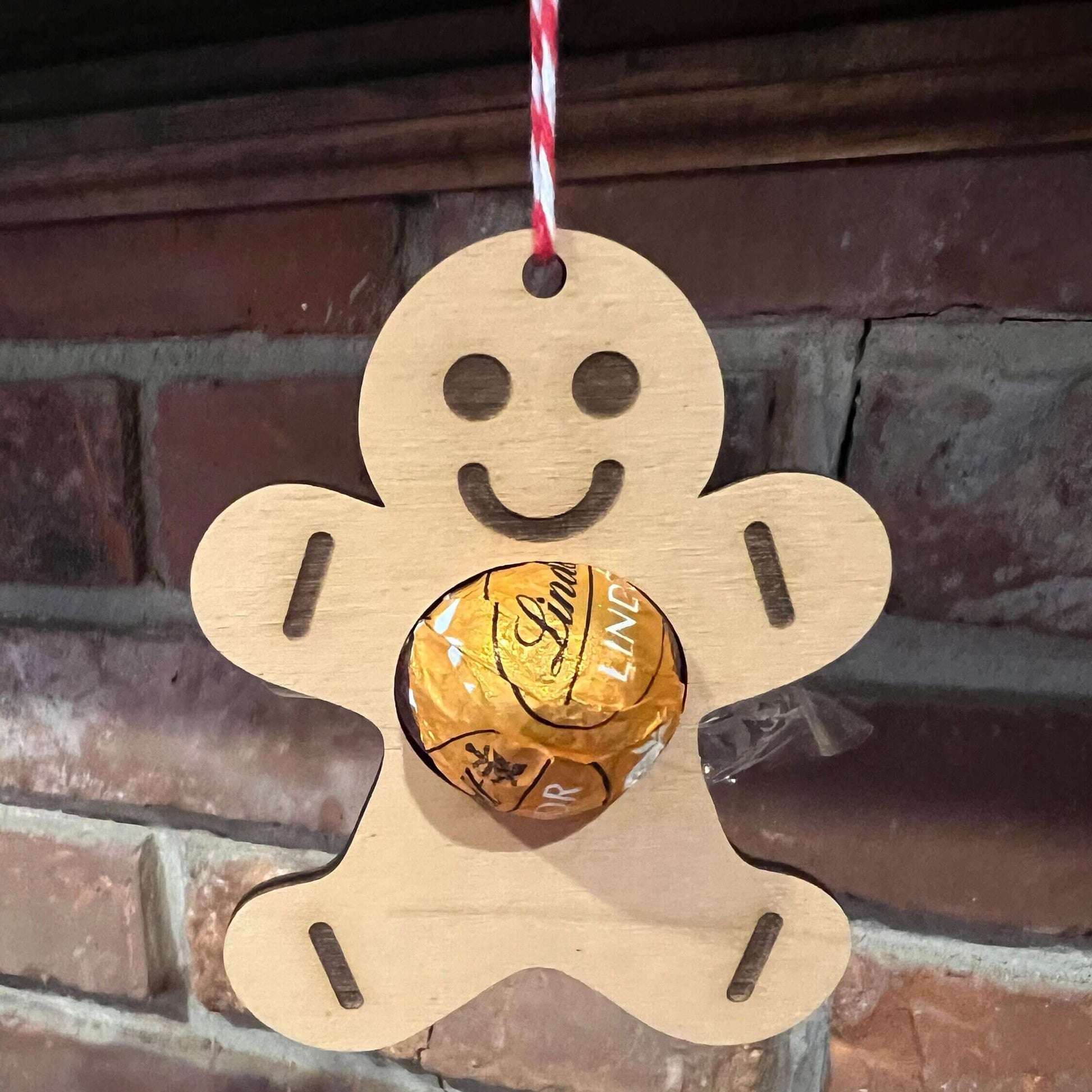 The Wet Nose Woodworks Digital Ornament Templates include a reindeer Lindt Lindor chocolate holder—perfect for festive designs. This laser-ready SVG/Lightburn file set features gingerbread man, snowflake, and reindeer ornaments.