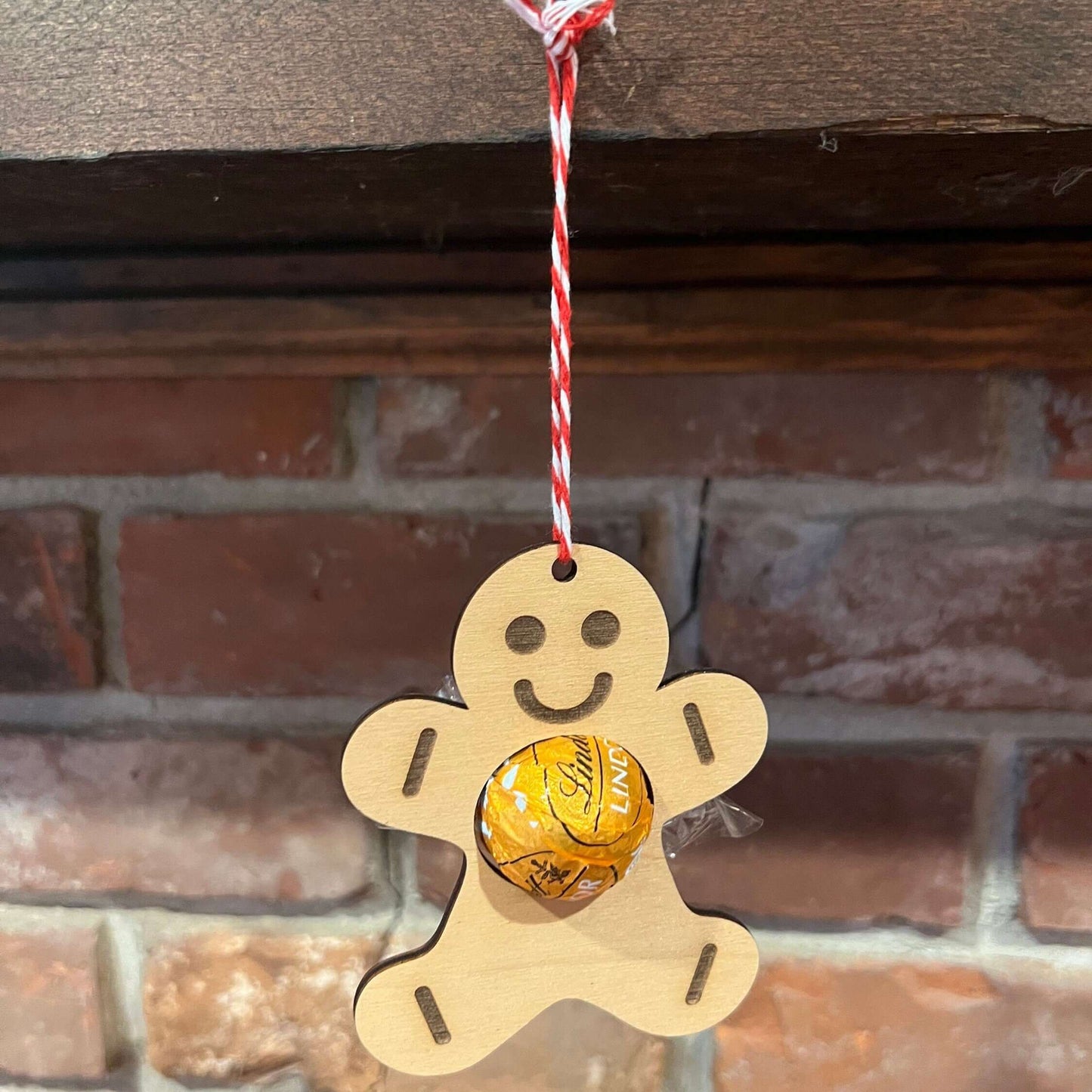 The Wet Nose Woodworks Digital Ornament Templates include a reindeer Lindt Lindor chocolate holder—perfect for festive designs. This laser-ready SVG/Lightburn file set features gingerbread man, snowflake, and reindeer ornaments.