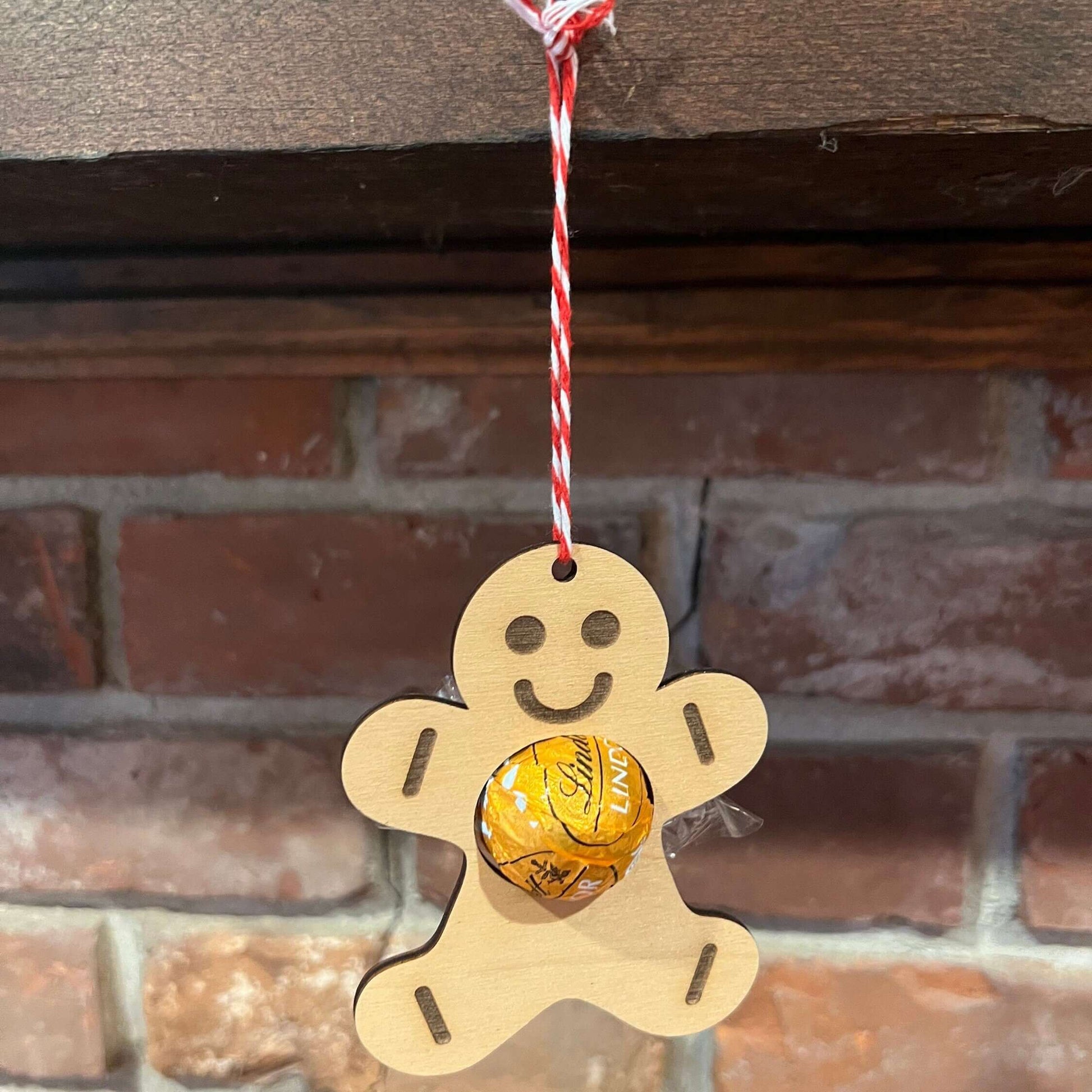 The Wet Nose Woodworks Digital Ornament Templates include a reindeer Lindt Lindor chocolate holder—perfect for festive designs. This laser-ready SVG/Lightburn file set features gingerbread man, snowflake, and reindeer ornaments.