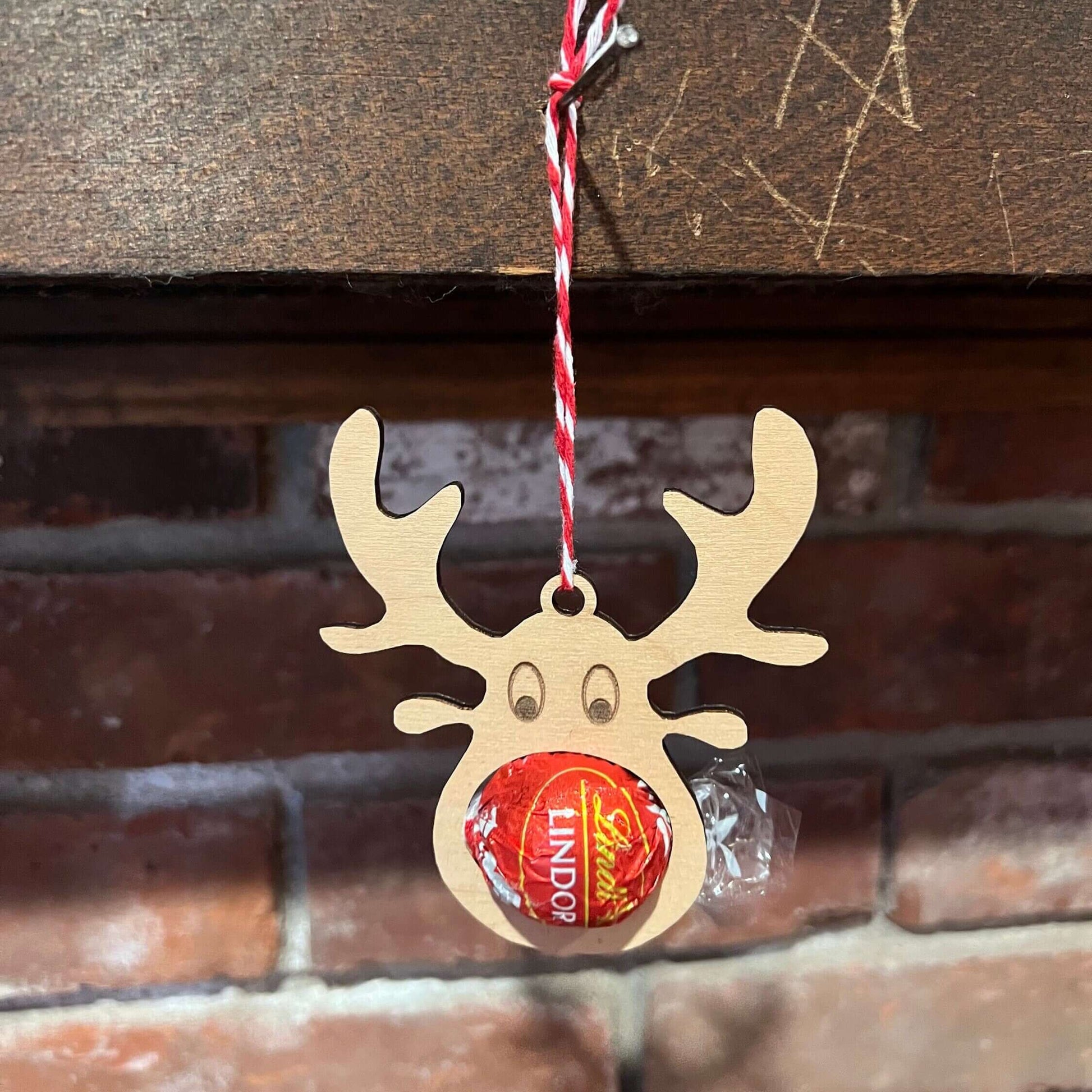 The Wet Nose Woodworks Digital Ornament Templates include a reindeer Lindt Lindor chocolate holder—perfect for festive designs. This laser-ready SVG/Lightburn file set features gingerbread man, snowflake, and reindeer ornaments.