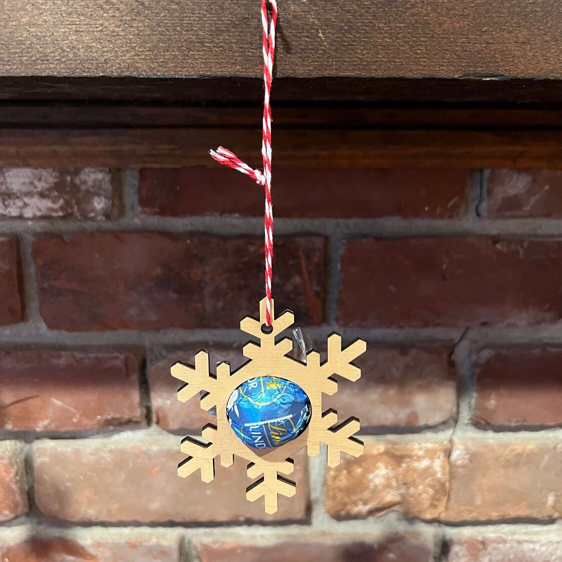 The Wet Nose Woodworks Digital Ornament Templates include a reindeer Lindt Lindor chocolate holder—perfect for festive designs. This laser-ready SVG/Lightburn file set features gingerbread man, snowflake, and reindeer ornaments.