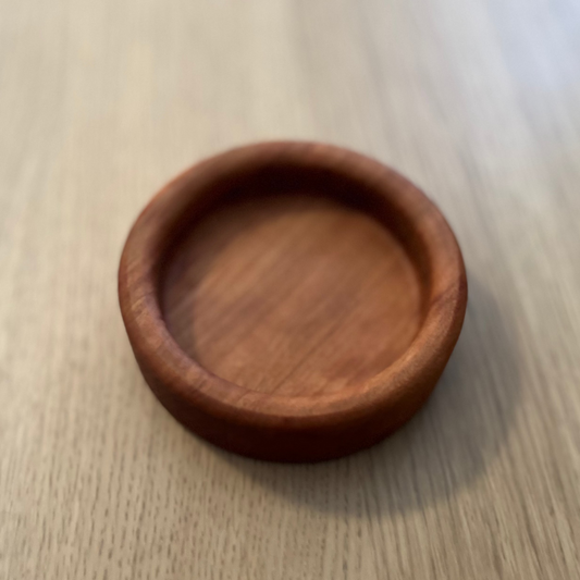 Wooden coaster on a light wooden surface