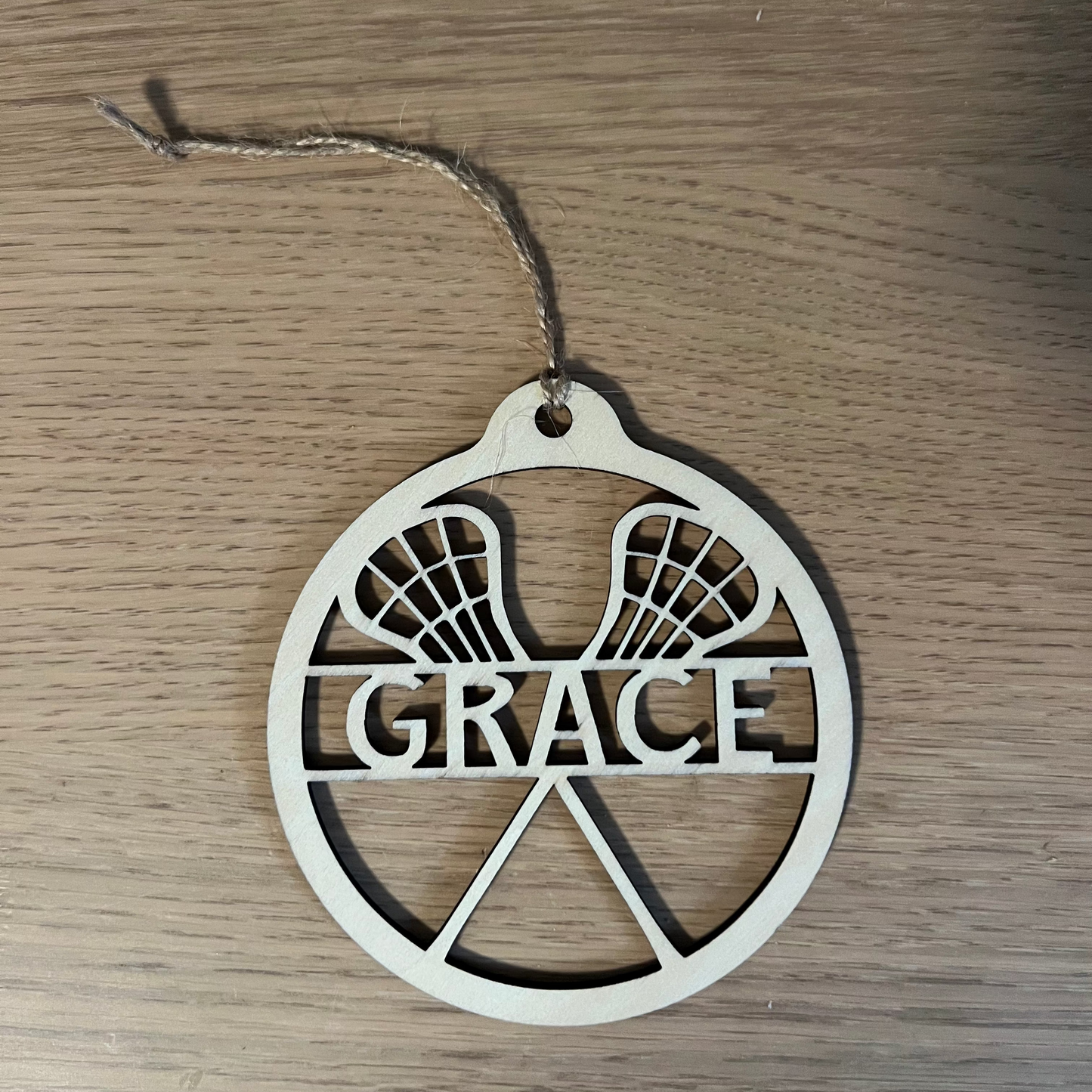 Wooden ornament with 'GRACE' engraved on a wooden surface