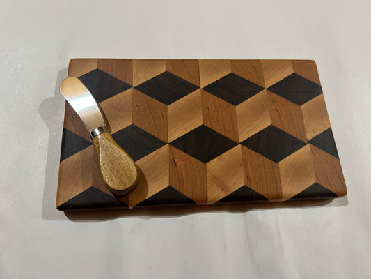 Wooden cutting board with geometric pattern and a cheese knife on a light gray background