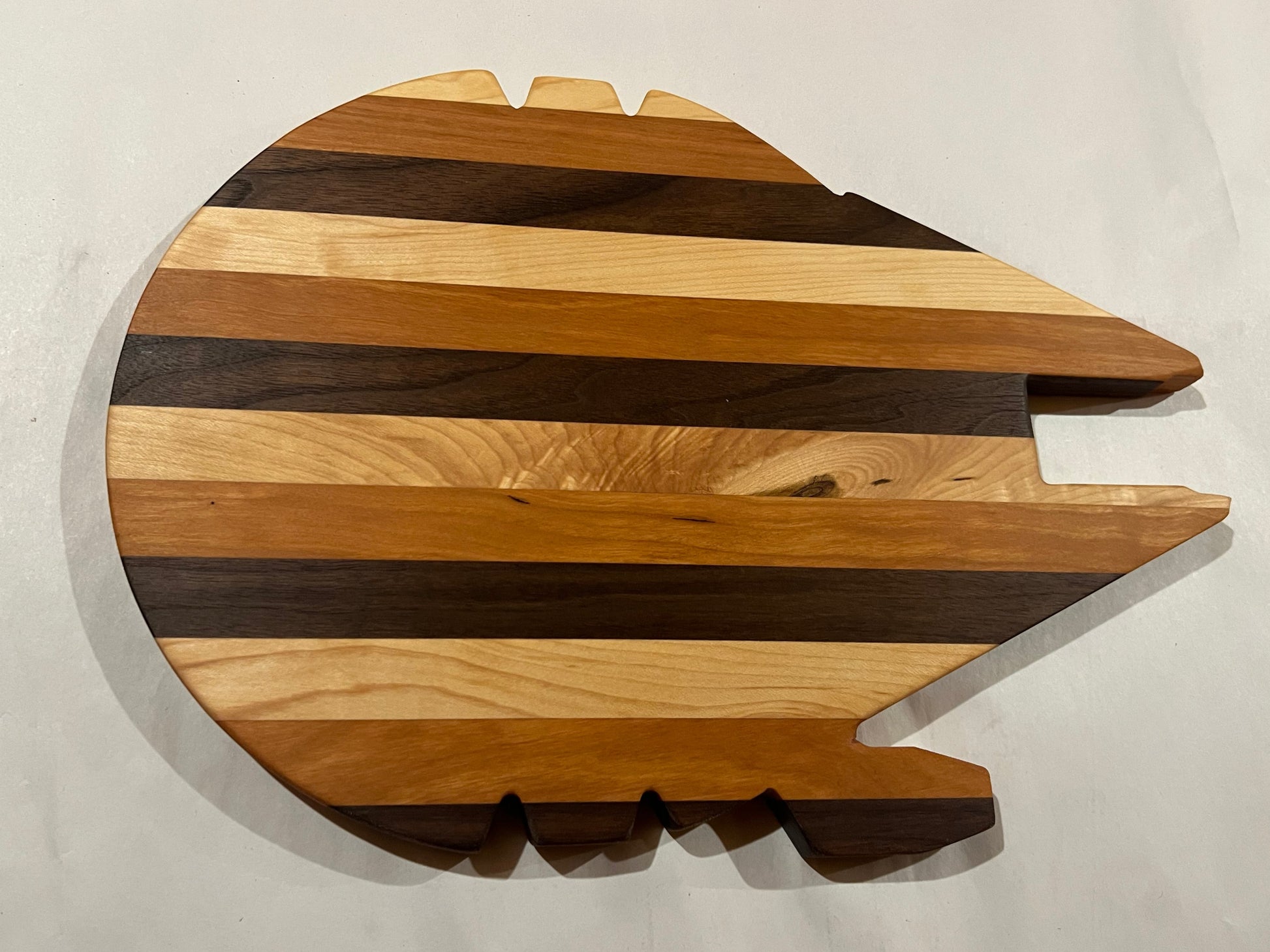 Wooden cutting board with a unique shape on a white background