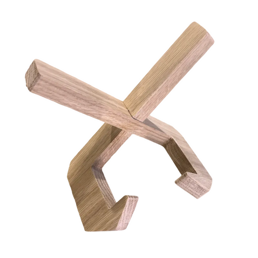 Wooden X-shaped object on a textured surface