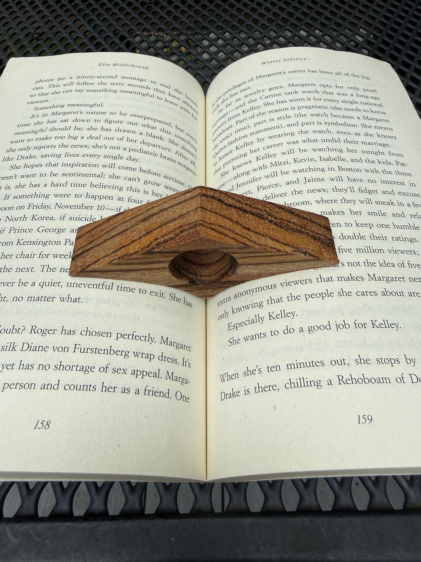 Wooden thumb page holder slipped over thumb while reading a book