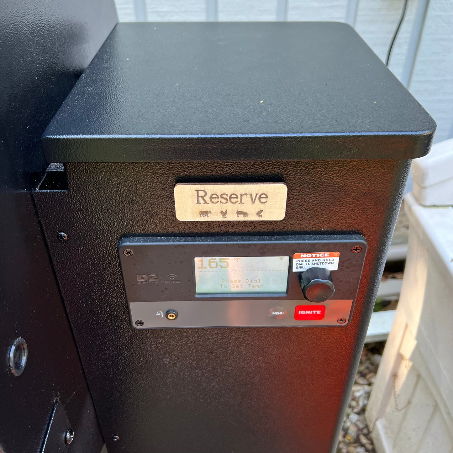 A collage displays Wet Nose Woodworks Laser Cut File: Smoker Grill Wood Pellet Label Magnets—Mesquite and Reserve—plus black-and-white SVG design templates, a Reserve label on a grill, and Lightburn/xTool file icons.