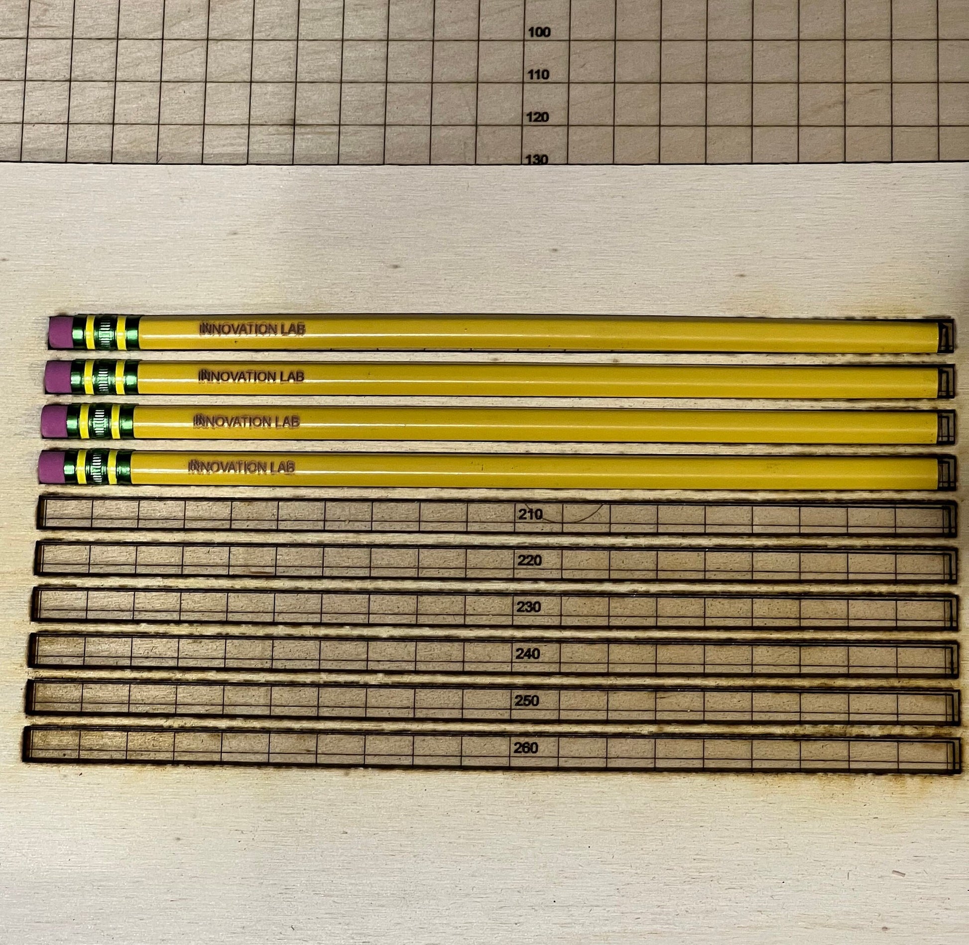 Five yellow pencils and engraved rulers sit on wood. Text: Laser Engraving Pencil Alignment Jig Digital File with LightBurn, SVG, xTool XCS—perfect for xTool or Glowforge by Wet Nose Woodworks. Back to School Supplies & Laser Engraving Jig SVG shown.