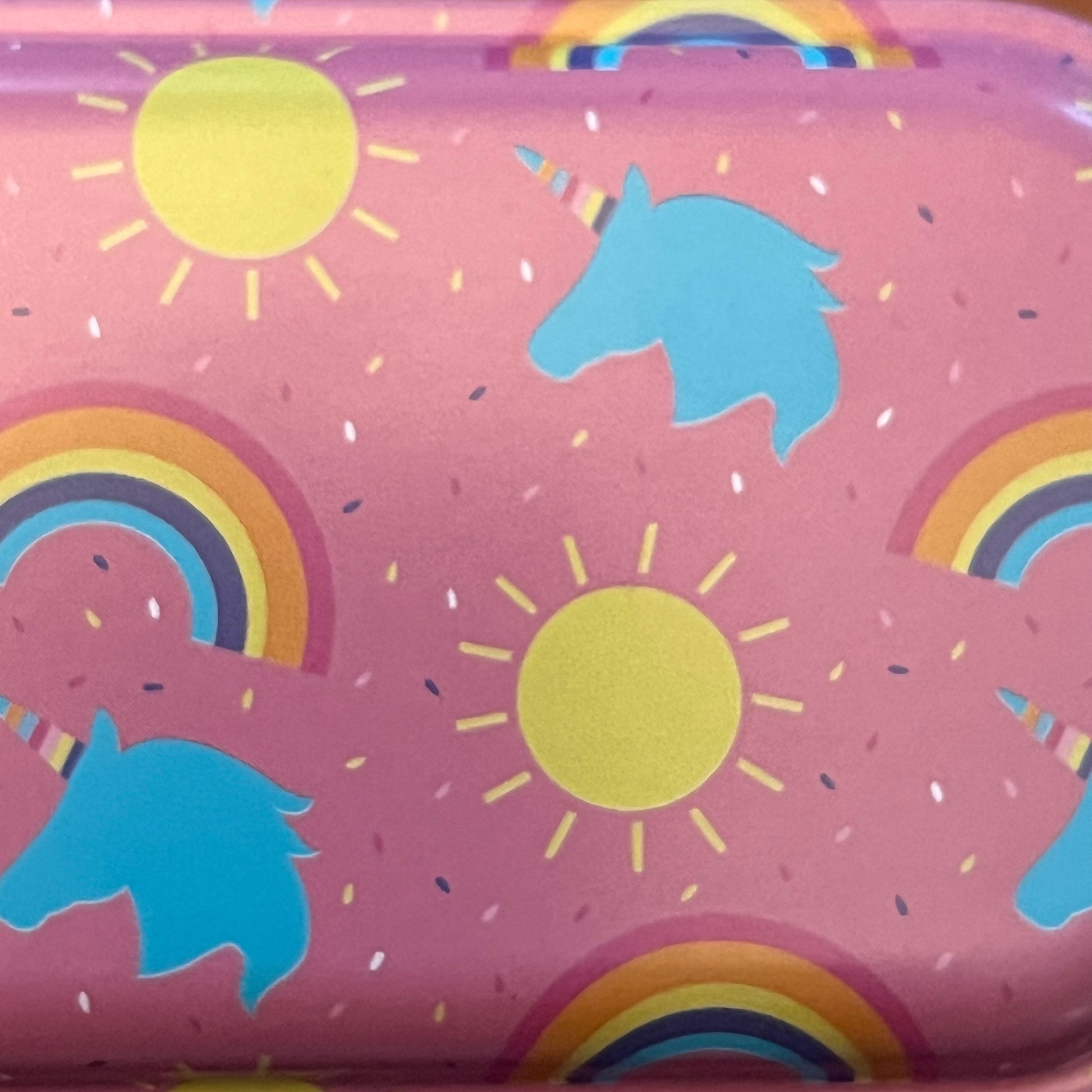 Wet Nose Woodworks Metal Pencil Boxes come in four colorful designs—Kaylea (animal print), Celia (striped), Grace (rainbows & crowns), and Tommy (dinosaurs)—with snap closures, keeping desks stylish and organized.