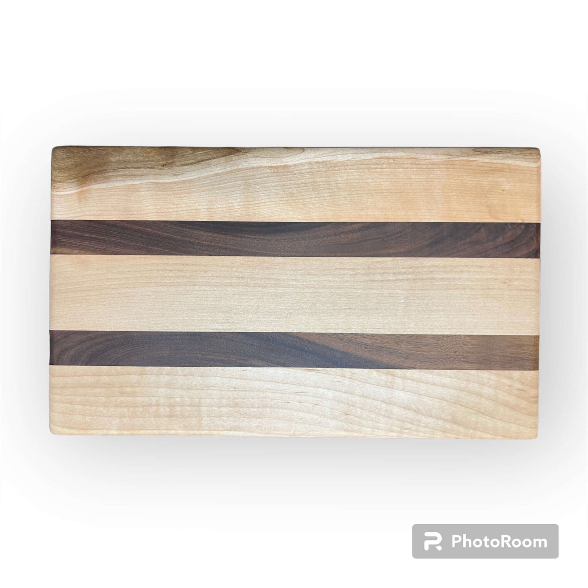 Three Wet Nose Woodworks Walnut and Maple Racing Stripe Cutting Boards are arranged on a white background, featuring alternating light and dark wood stripes. The largest board is on top, with two smaller boards below.