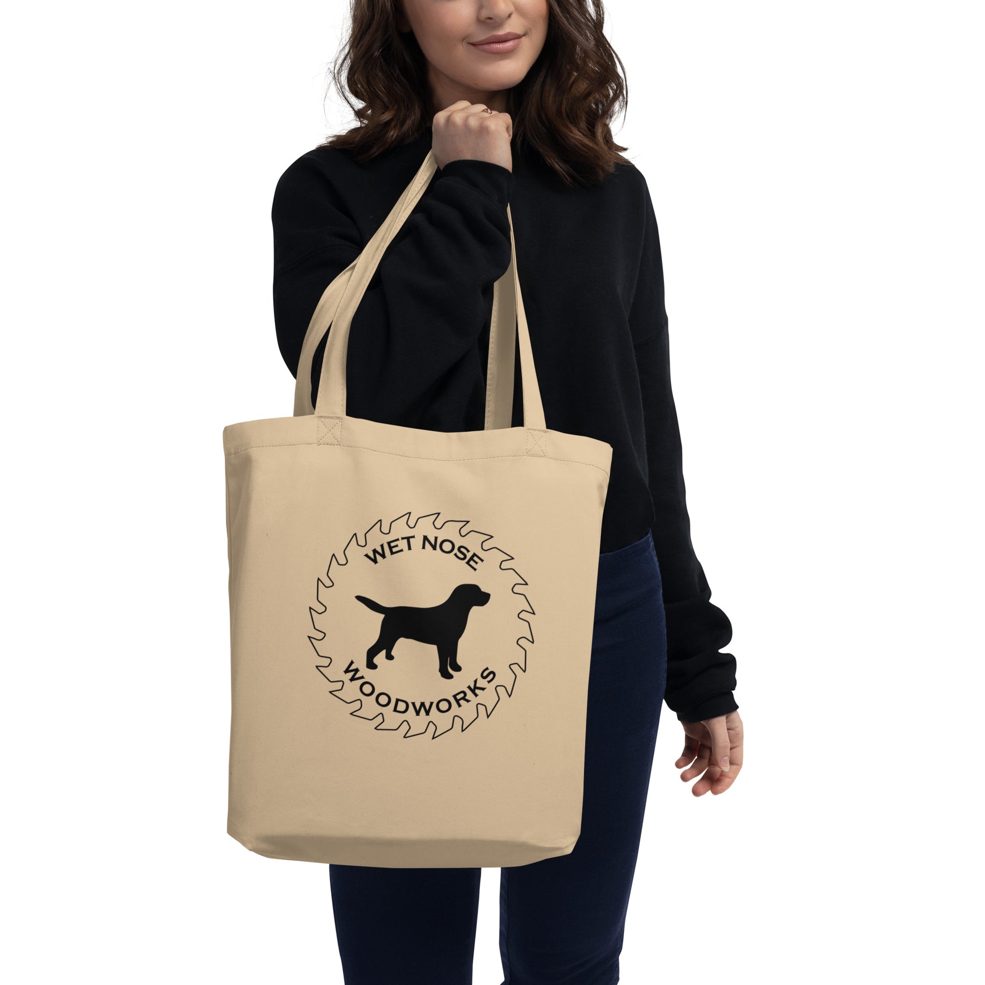 Woman carrying Wet Nose Woodworks oyster organic cotton logo tote bag, front view